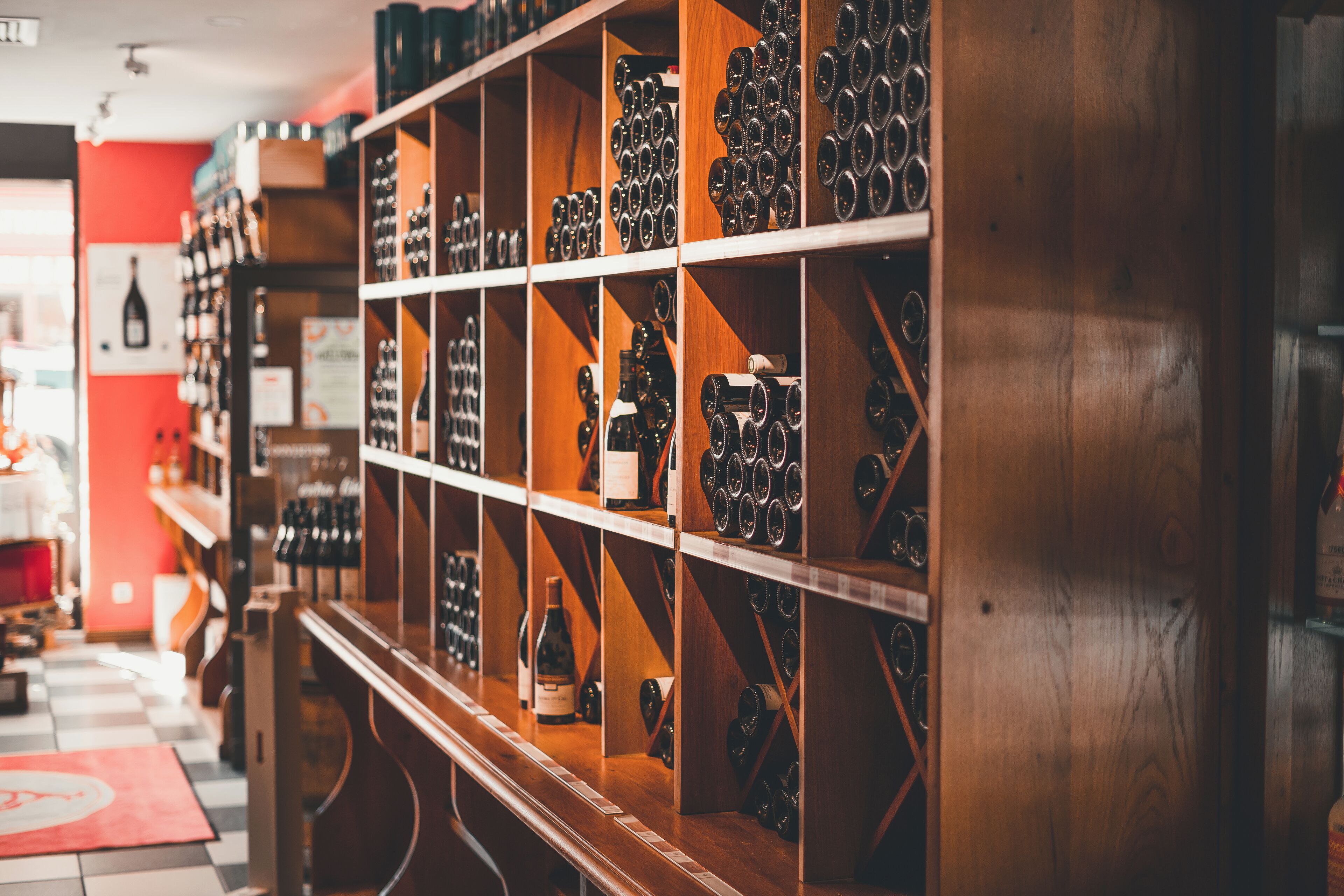A wine cellar with shelves of wine bottles.