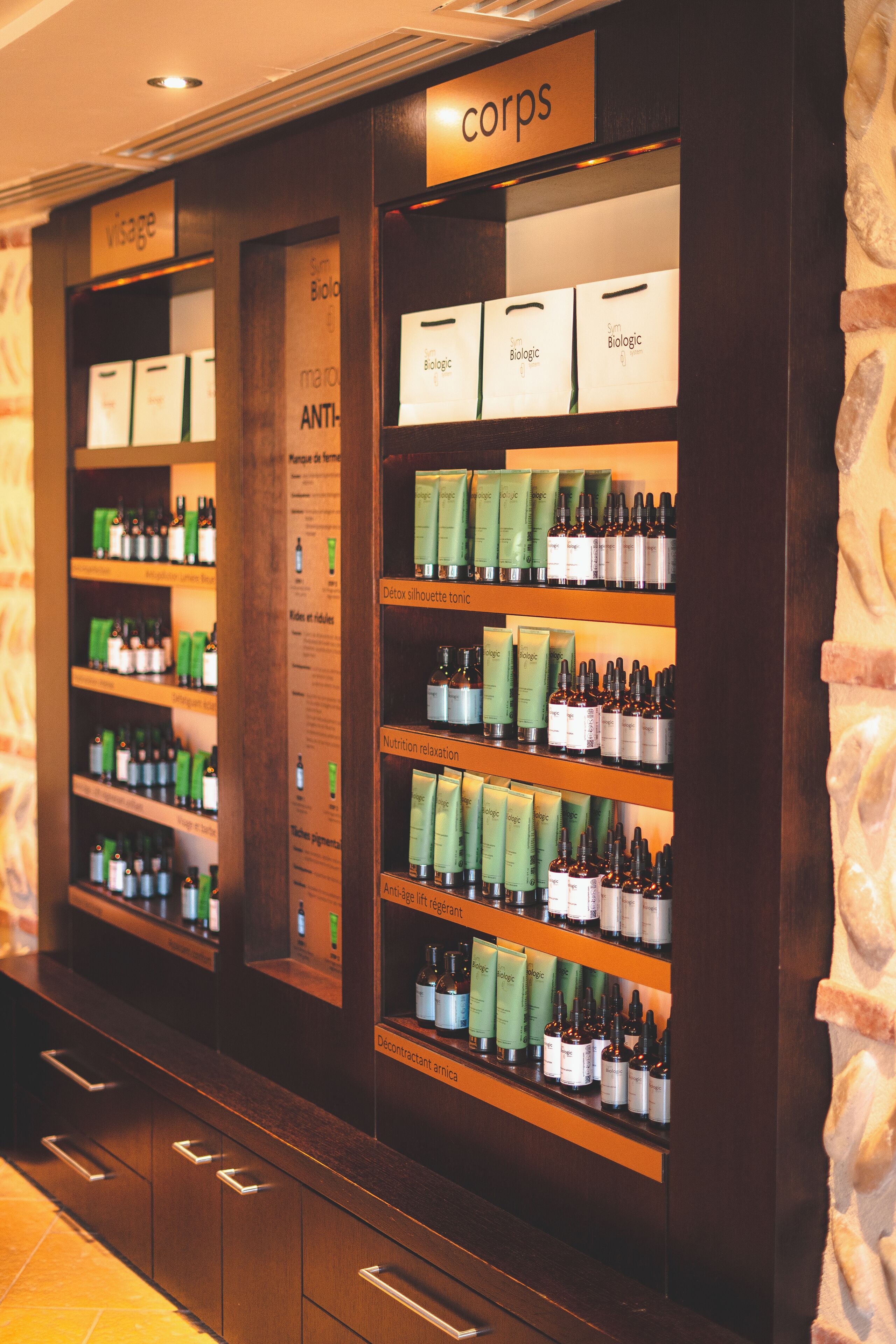 A section of a hotel with shelves stocked with various health and wellness products, including supplements and skincare items.