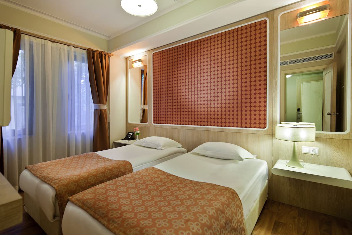 Family Room | Minibar, in-room safe, free WiFi, bed sheets