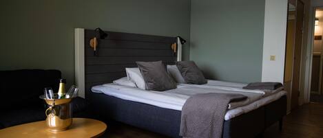 A bedroom with a bed, bedside tables, and a nightstand.