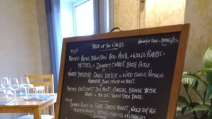 A menu board with a list of food items and prices, placed on a table in a restaurant setting. - Orchard Lodge & Wolds Restaurant (Scarborough)