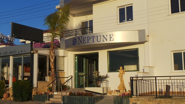 A building with a sign reading "NEPTUNE". - Neptune Hotel Apartments (Pegeia)