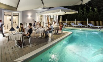 Seasonal outdoor pool, open 9:30 AM to 11:00 PM, pool umbrellas