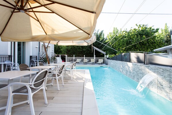 Seasonal outdoor pool, open 9:30 AM to 11:00 PM, pool umbrellas