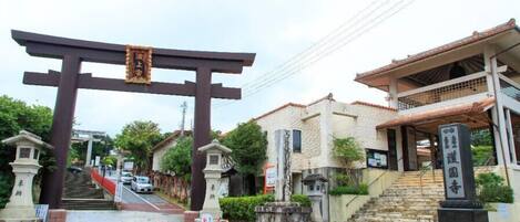 Un tradizionale torii giapponese all'ingresso di un edificio, con una scala che vi conduce.