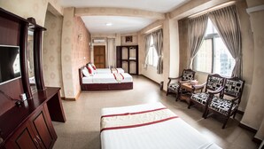 A hotel room with two beds, a TV, a desk, and a chair. - Diamond Crown Hotel (Yangon)