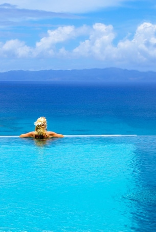 Outdoor pool, an infinity pool, pool umbrellas, sun loungers