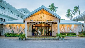 The entrance of Paras Beach Resort with a prominent sign, a covered entrance, and potted plants in front. - Paras Beach Resort (Mambajao)