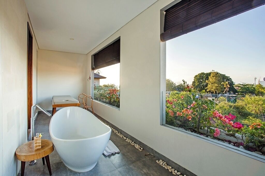 legong keraton suite, larger suite, bathtub & balcony | bathroom | separate bathtub and shower, rainfall showerhead, free toiletries