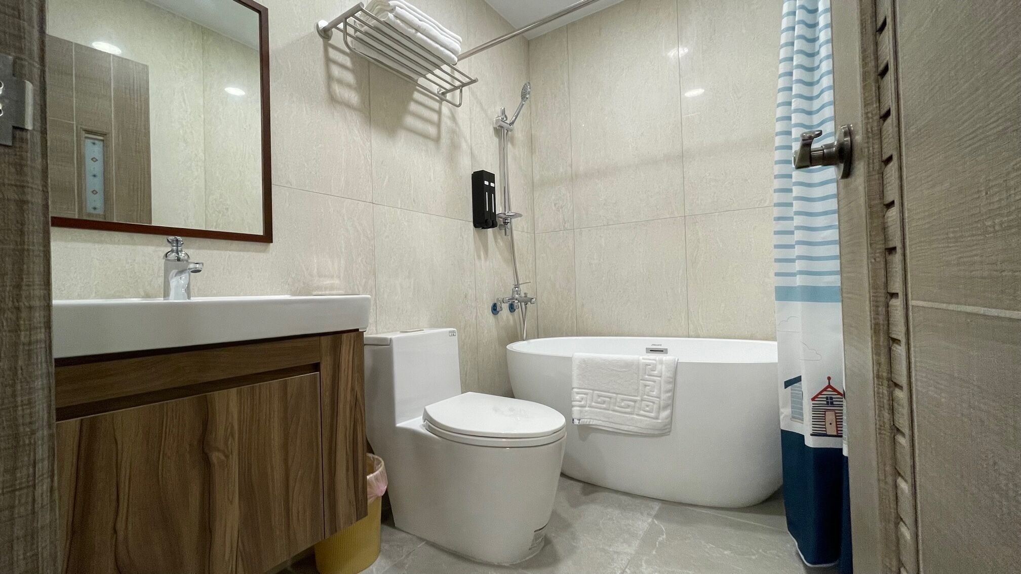 A modern bathroom with a toilet, sink, and bathtub.