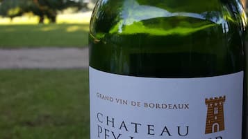 A bottle of Chateau Pey La Tour wine with a label indicating it is a Grand Vin de Bordeaux from 2011.