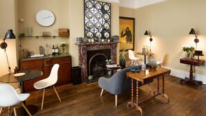 Un salón acogedor con chimenea, muebles de madera y una mesa redonda con sillas.