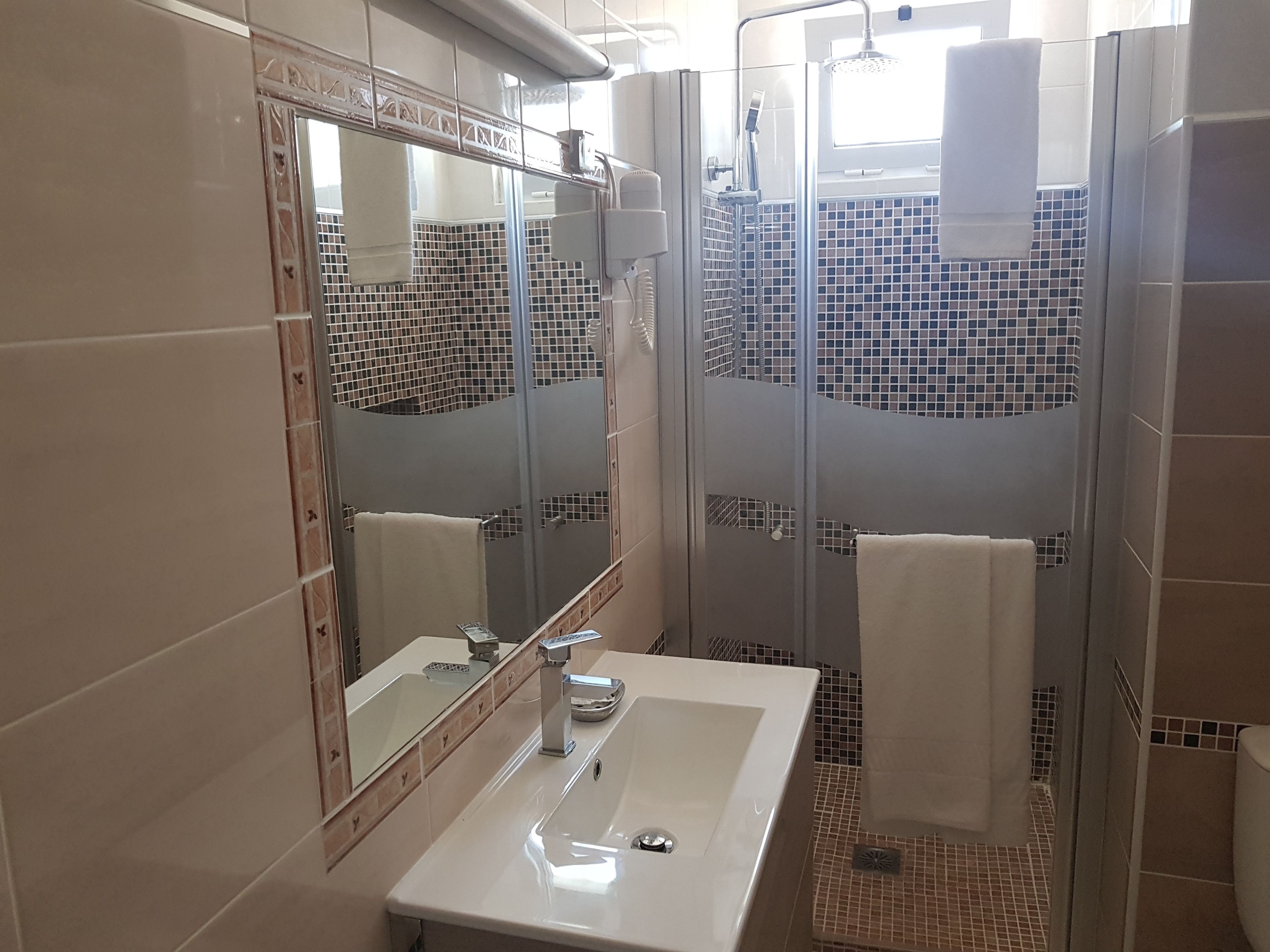 shower, rainfall showerhead, hair dryer, towels