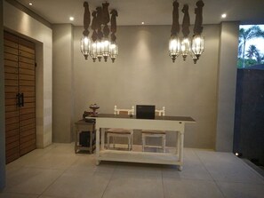 A modern kitchen with a central island, pendant lighting, and a wooden cabinet. - Jabu Beach Villa (Canggu)