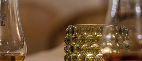 A glass table with a reflective surface and a decorative glass object.