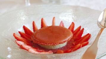 A dessert on a glass plate with a spoon.