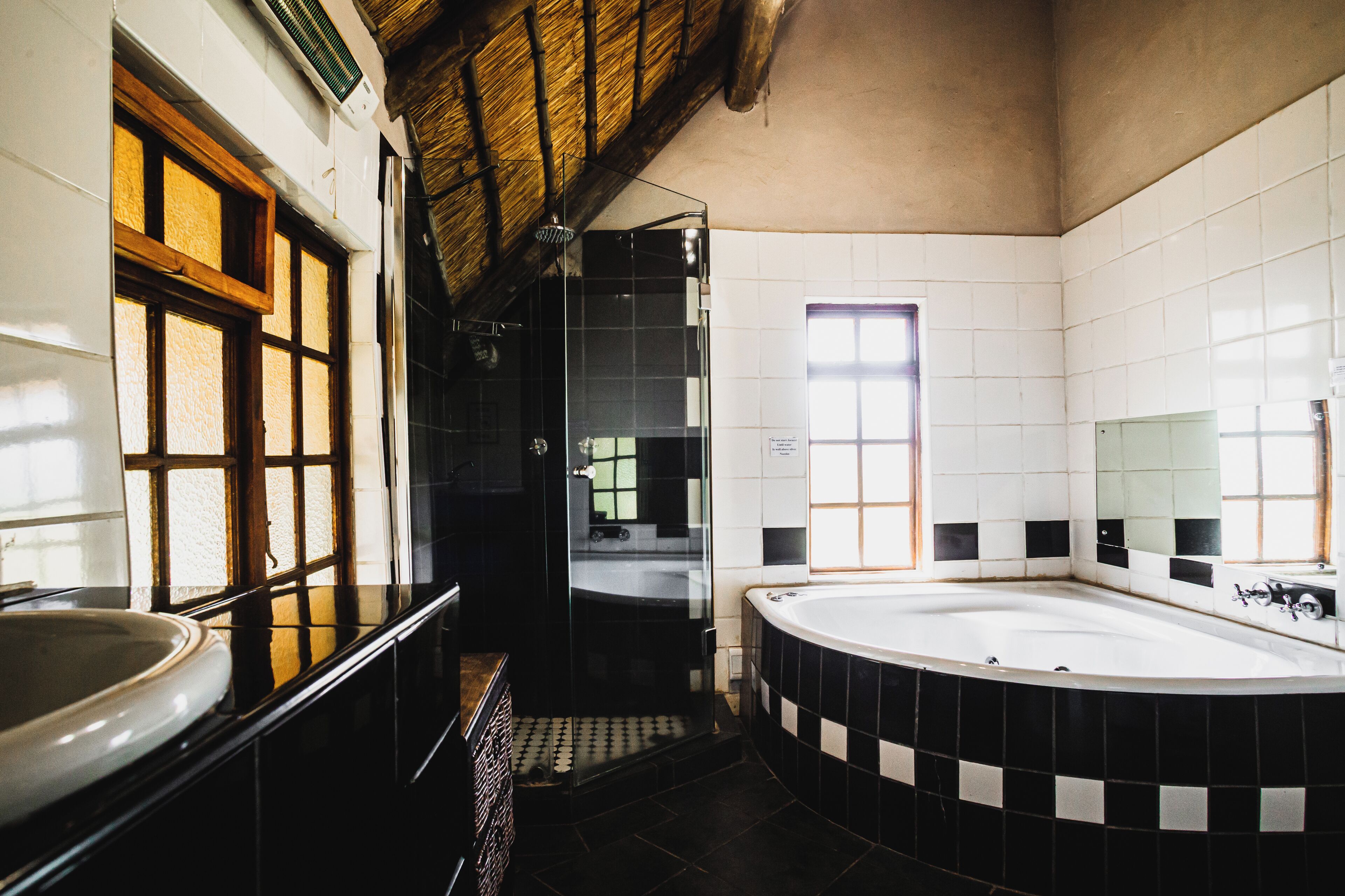 A bathroom with a bathtub, a shower, and a sink.