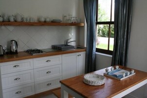 Fridge, microwave, coffee/tea maker, cookware/dishes/utensils