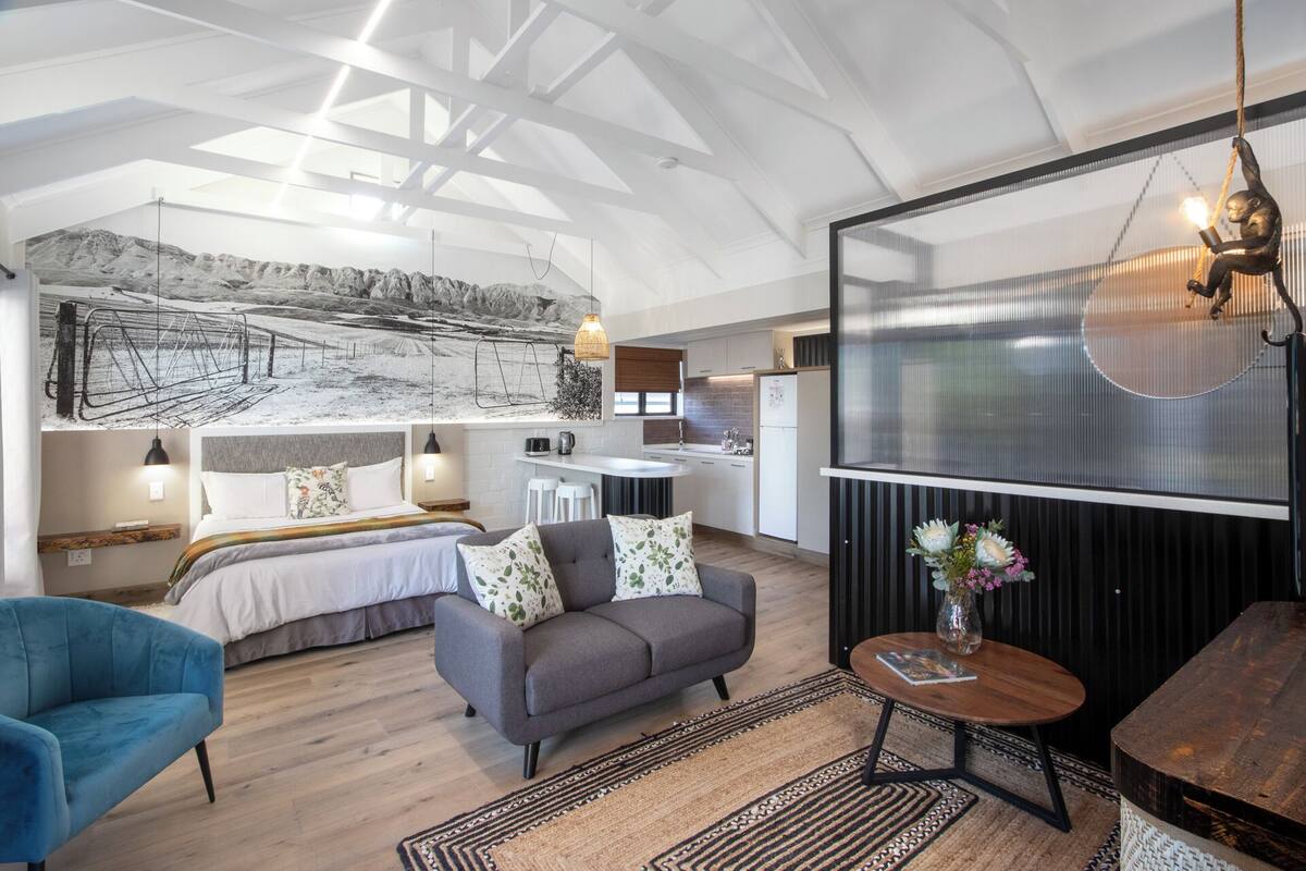 A modern interior with a loft-style bedroom, a kitchen, and a living area.