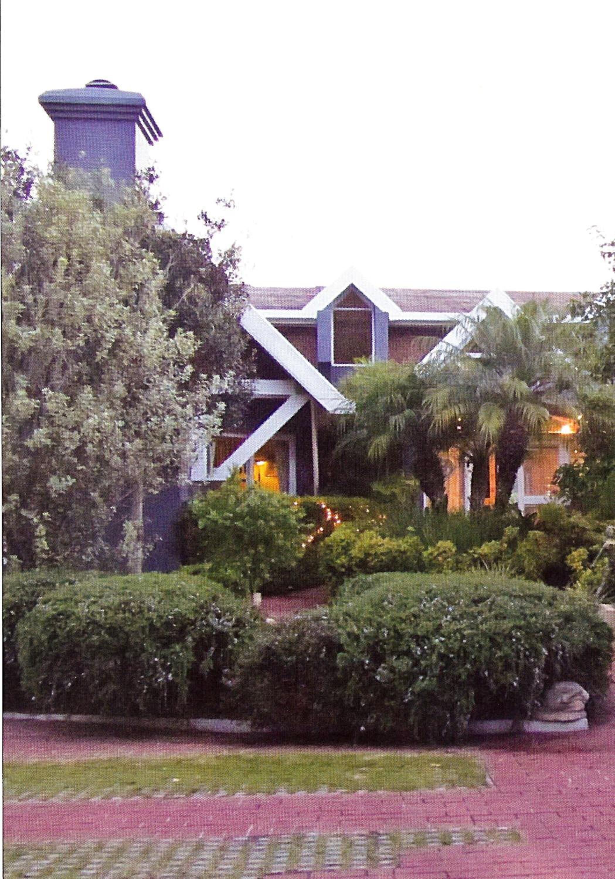 A building with a distinctive architectural design, featuring a prominent tower and a sloped roof.