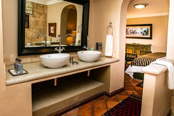A bathroom with two sinks, a large mirror, and a vanity. - Terra Casa (Rustenburg)