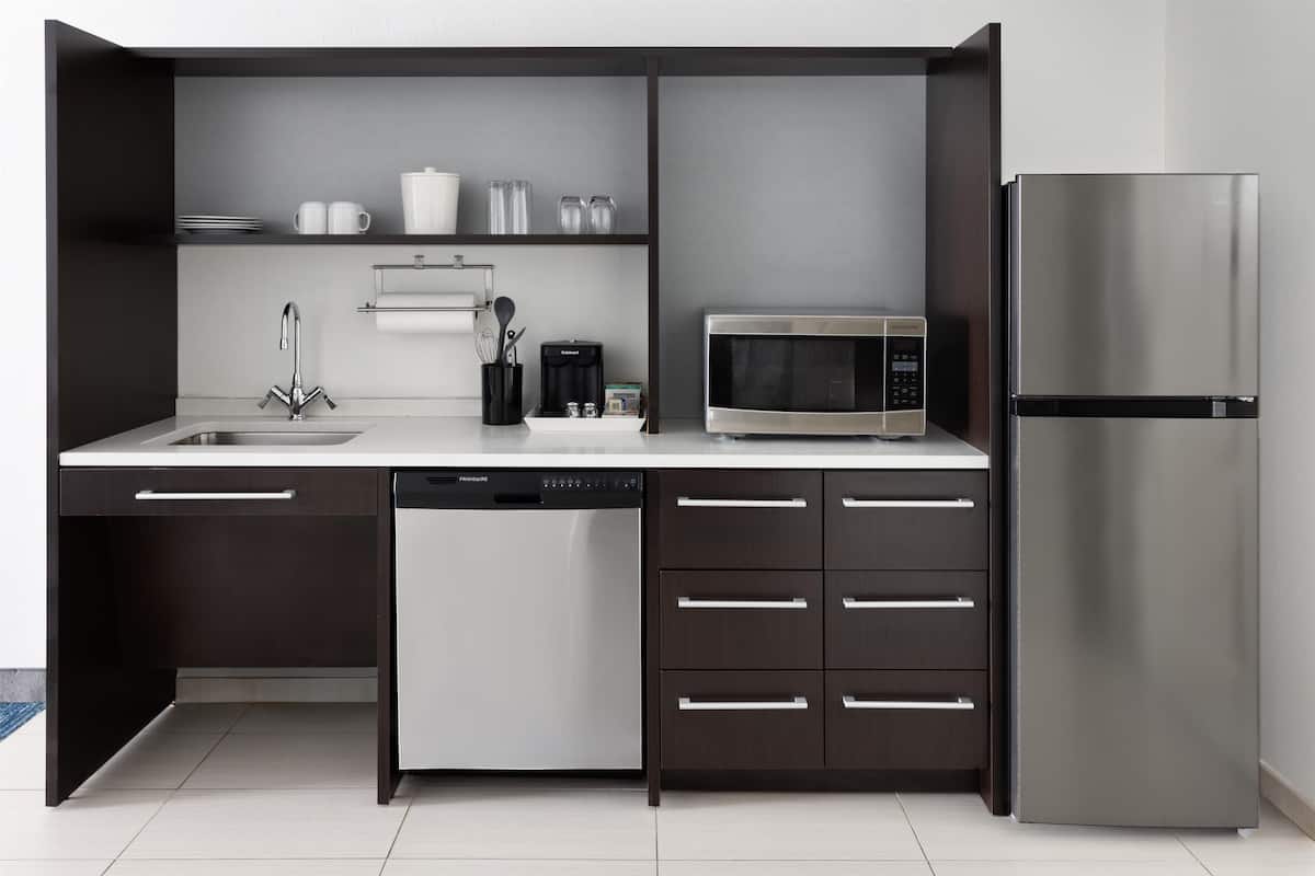 full-sized fridge, microwave, dishwasher, cookware/dishes/utensils