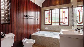 Ein Badezimmer mit Badewanne, Toilette, Bidet und Waschbecken.