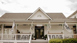 A hotel with a porch, a sign reading "Coffee", and flags. - Blue Ridge Inn Bed & Breakfast (Blue Ridge)