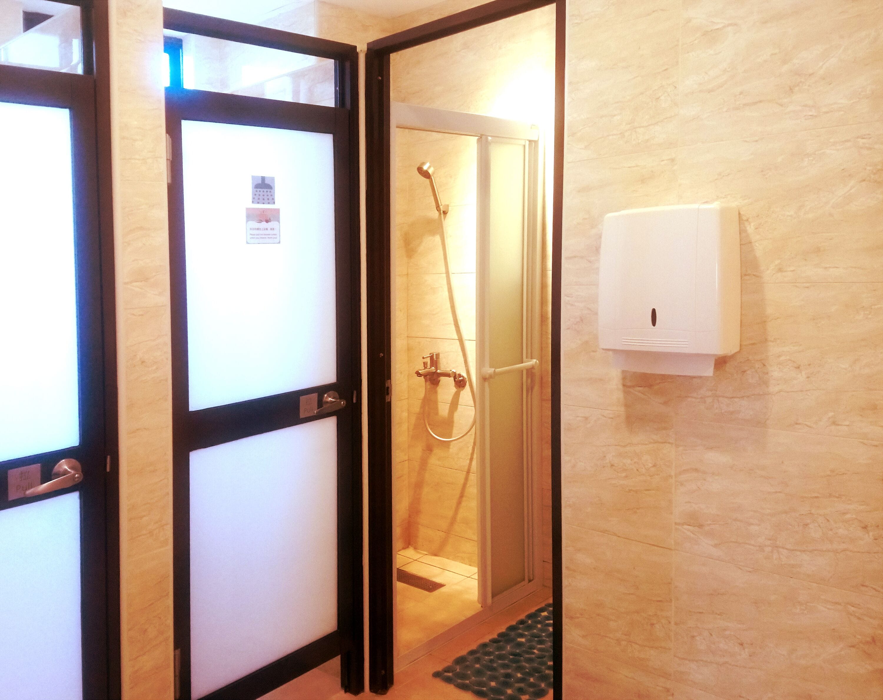 shower, hair dryer, towels, toilet paper