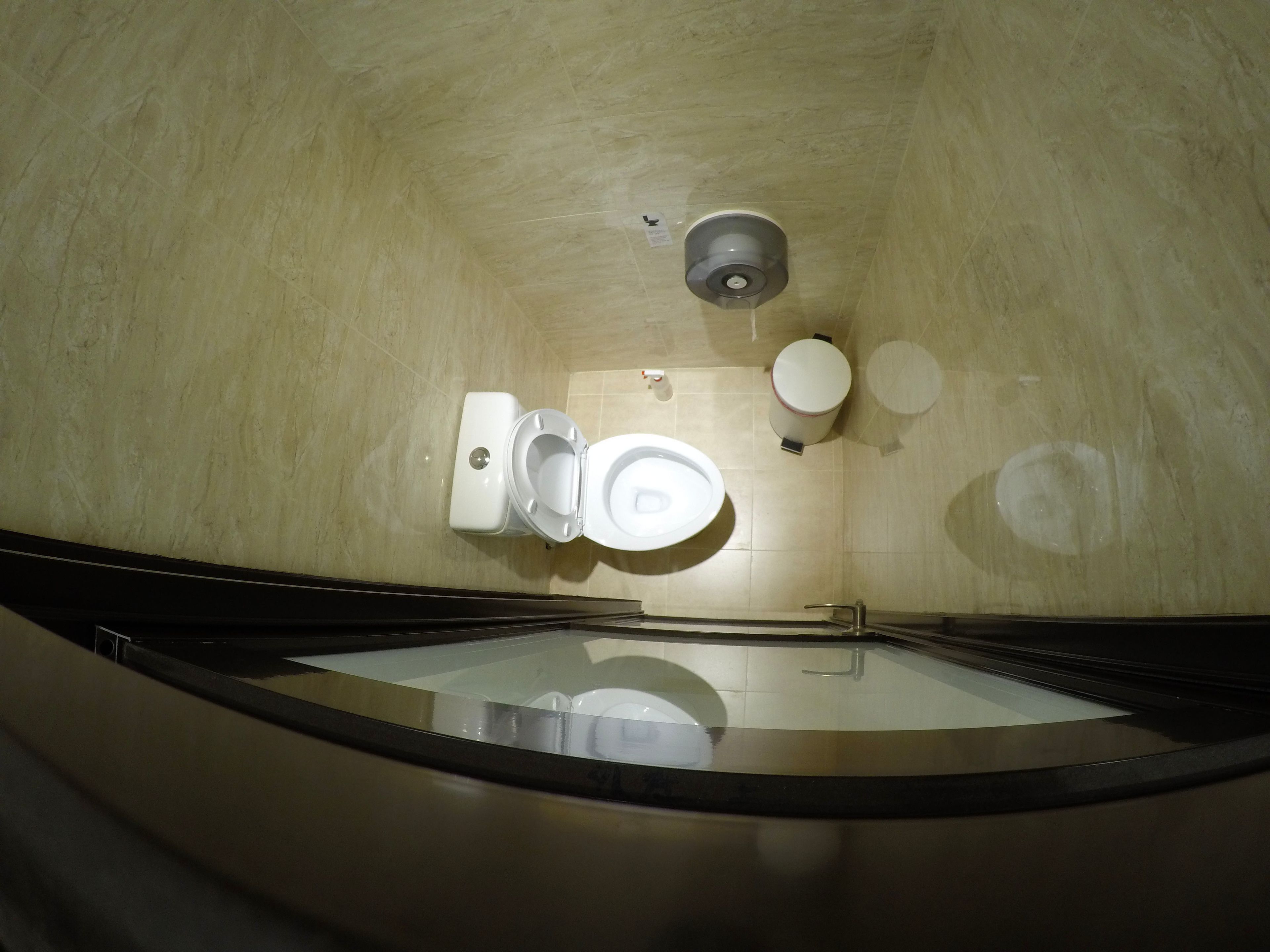A bathroom with a toilet, bidet, and a sink.