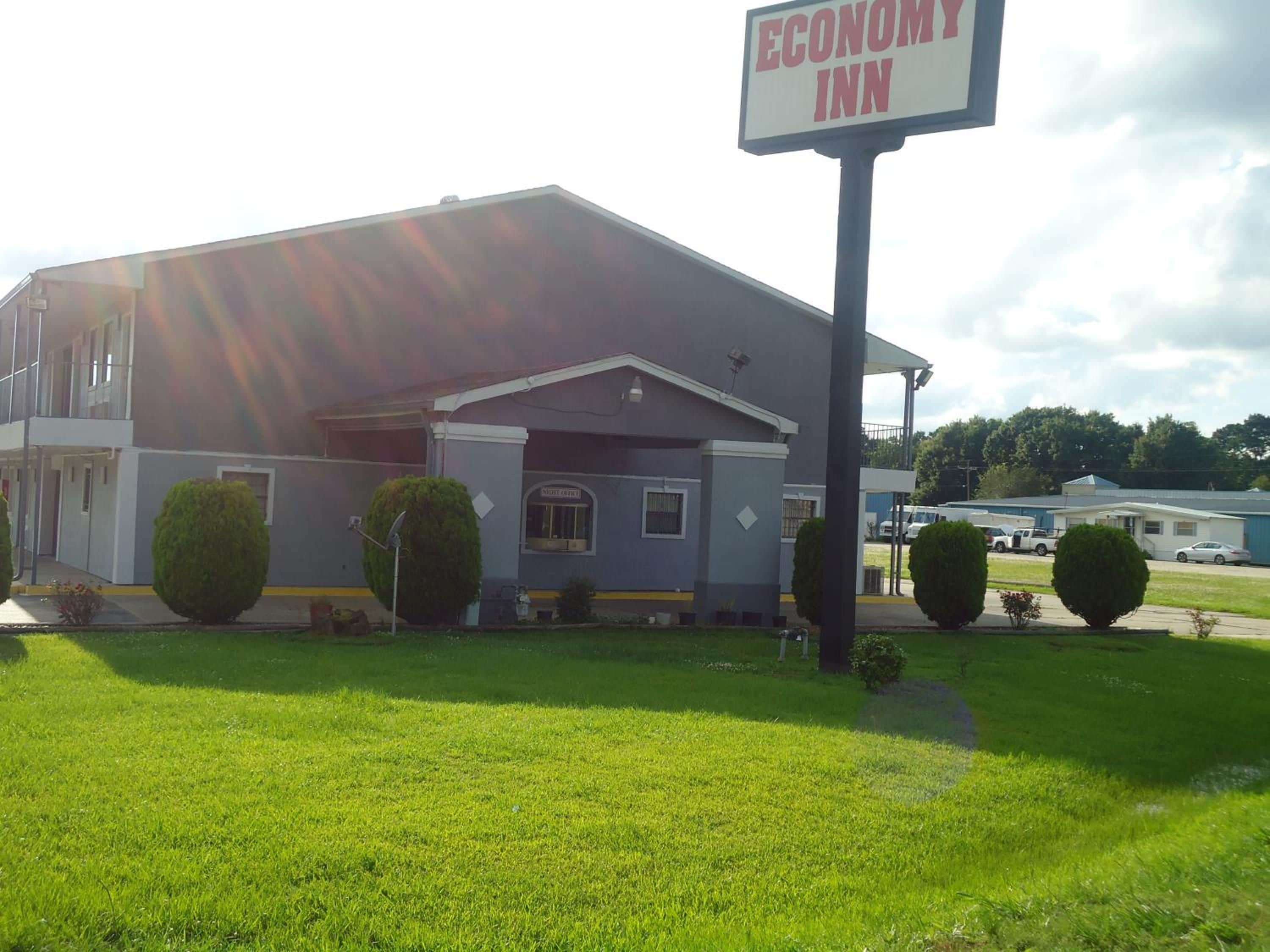 A two-story building with a sign reading 'Economy Inn.'