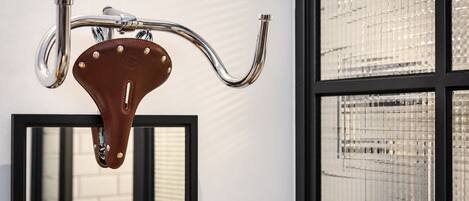 A bathroom with a chrome faucet and a mirror.