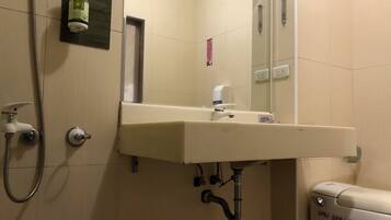 A bathroom with a sink, mirror, and toilet.