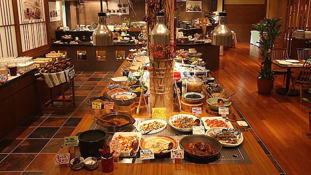 A buffet setup with various dishes and a central serving area.
