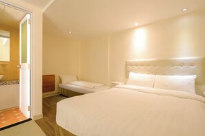 A hotel room with a large bed, a bedside table, a chair, and a bathroom visible through an open door. - B&B Cheung Chau (Cheung Chau)