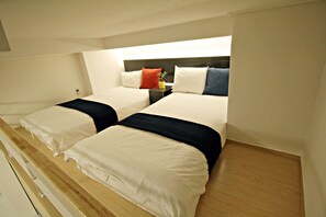 A twin room with two beds, a bedside table, and a nightstand. - The Sweet Castle Apartment (Seoul)