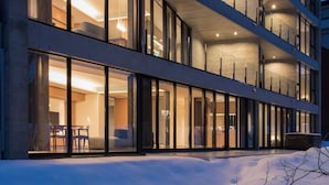 A modern building with multiple floors, large windows, and a snow-covered ground. - Kozue (Kutchan)