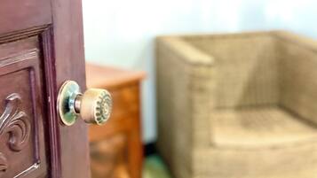 A close-up of a door with a round, metallic handle and a decorative panel.