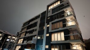 A multi-story building with balconies and large windows. - Snow Crystal (Kutchan)