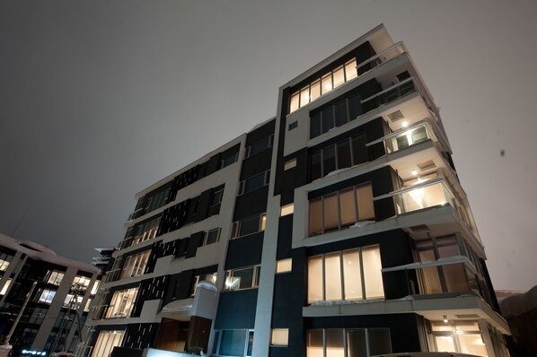 A multi-story building with balconies and large windows. - Snow Crystal (Kutchan)