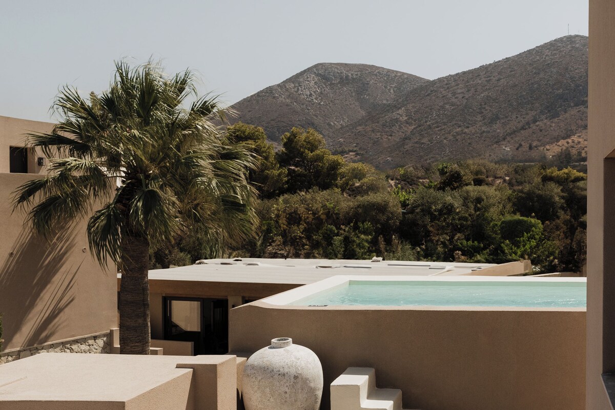 A modern outdoor seating area with a pool, a large vase, and a staircase.