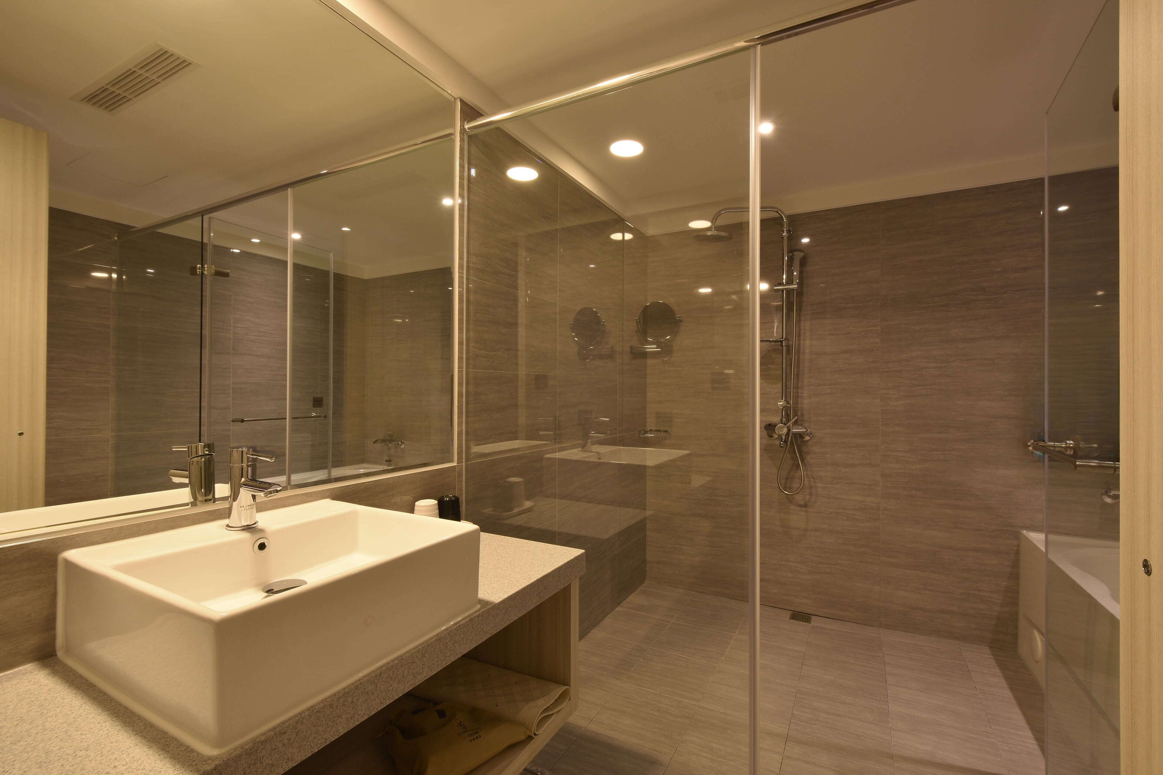 separate bathtub and shower, hair dryer, slippers, towels