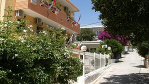 A hotel with a balcony, a sign reading "HOTEL KATERINA," and a flag. - Katerina Hotel (Nafplio)