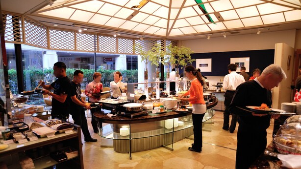 A buffet setup with multiple serving stations, a glass partition, and a variety of food items. - Hotel New Otani Nagaoka (Nagaoka)