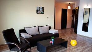 A modern living room with a sofa, a chair, a coffee table, and a large yellow ball. - Baltic Sol (Wladyslawowo)