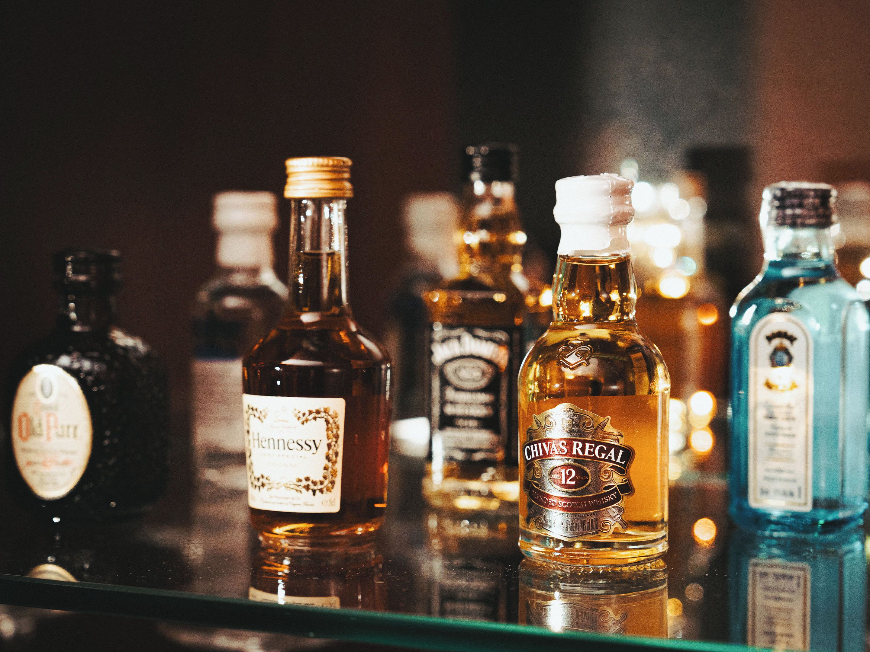A selection of liquor bottles on a shelf.