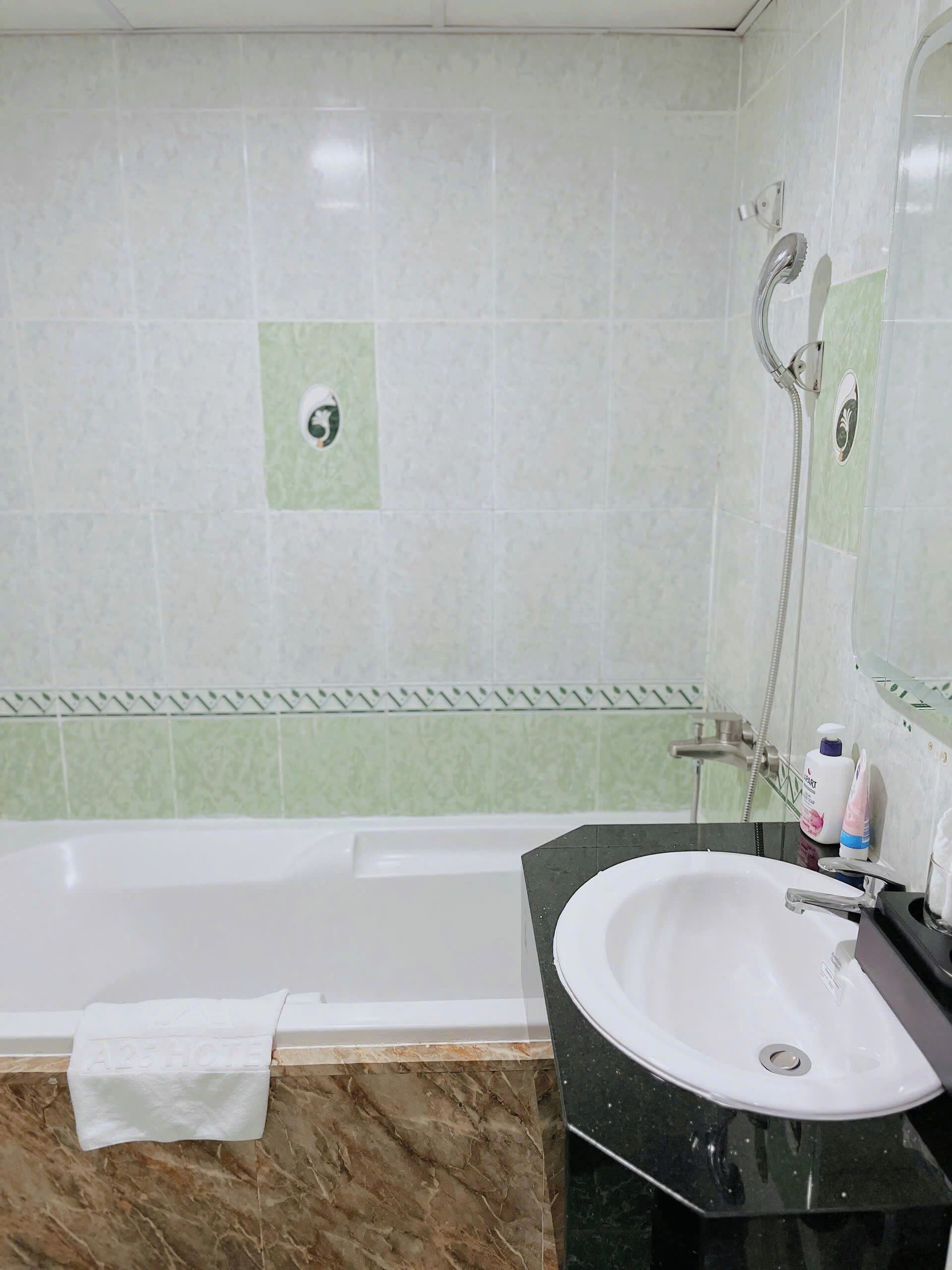 A bathroom with a bathtub, a sink, and a shower.