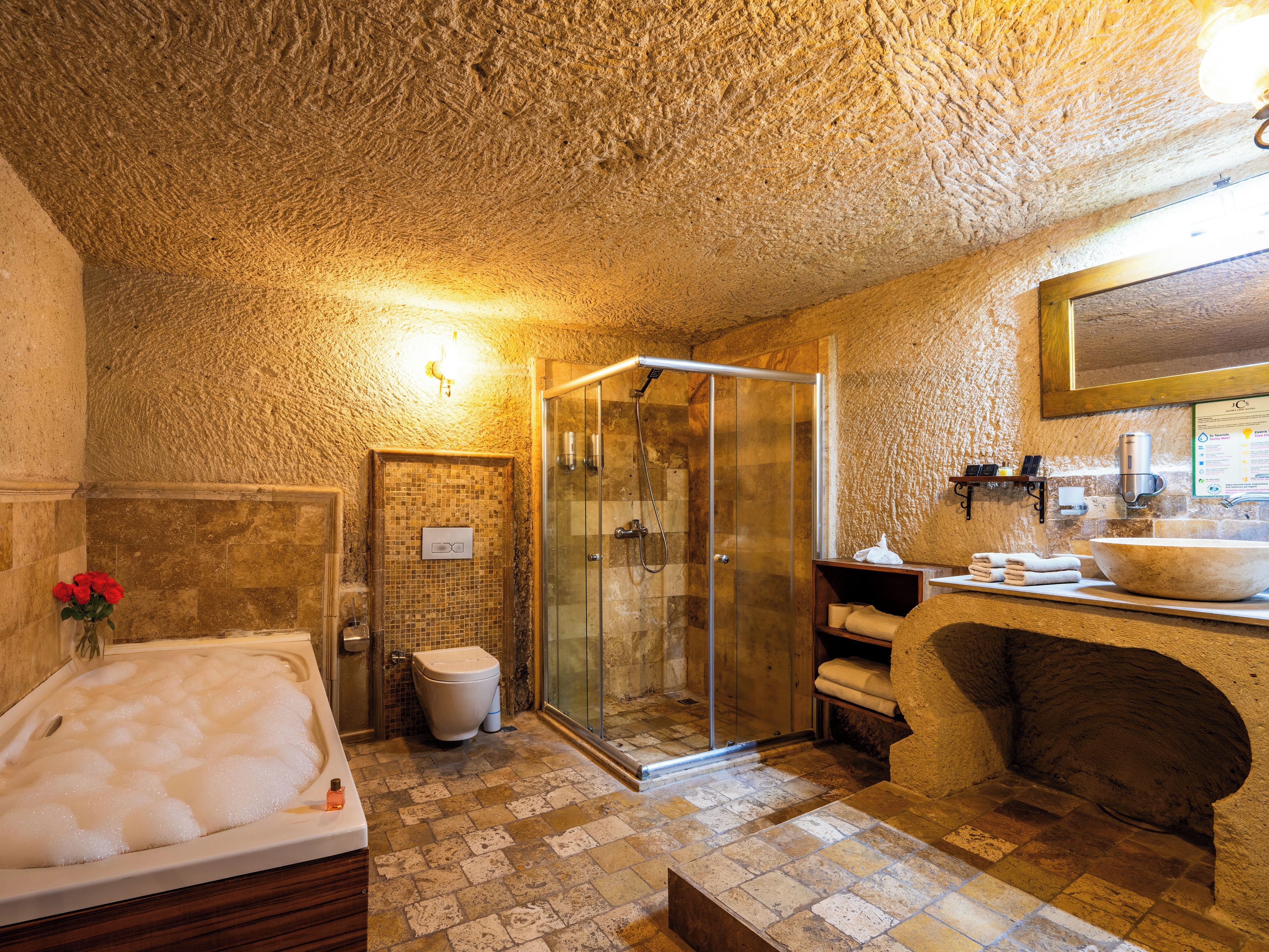 A bathroom with a bathtub, shower, and sink.