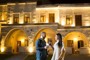 A stone building with arched doorways and warm lighting. - Jacob's Cave Suites (Avanos)