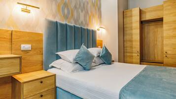 A modern bedroom with a bed, nightstands, and a wardrobe.